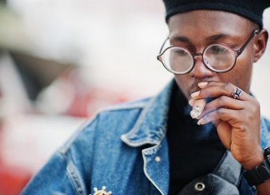 close-up-portrait-african-american-man-jeans-jacket-beret-eyeglasses-smoking-cigar(1)